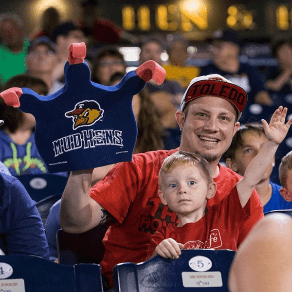 A dad and his son at a sporting event