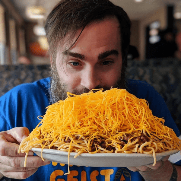 A man with a big bowl of Skyline Chili