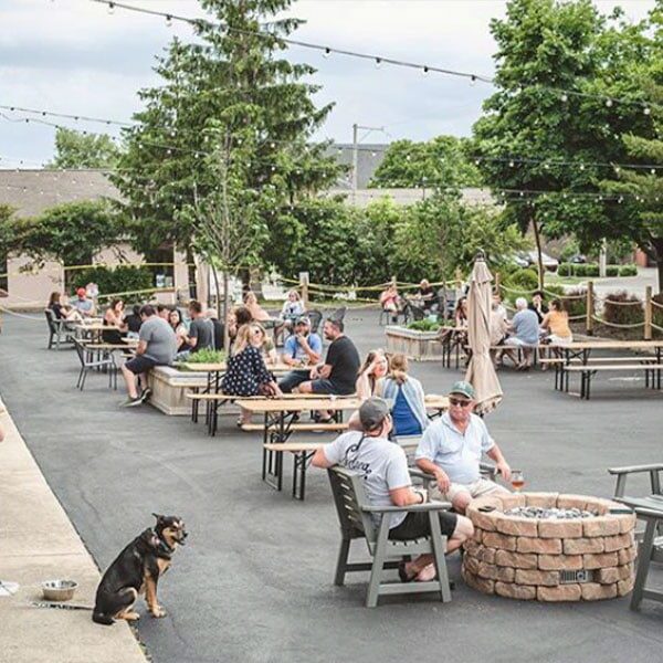 People at tables on a big patio